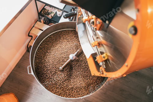 Preview: Close up of coffee roasting machine with coffee beans in small coffee manufacturing