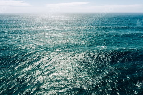 Preview: Aerial view over azure ocean with rolling waves. Top view to the ocean in summer sunny day - closeup
