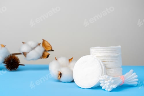 Preview: Cotton discs stack on blue paper background