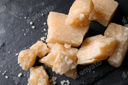 Preview: Pieces of delicious parmesan cheese on slate plate, top view