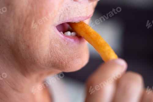 Preview: Close up on caucasian woman mouth eating french fries and enjoy it a lot - fried potato