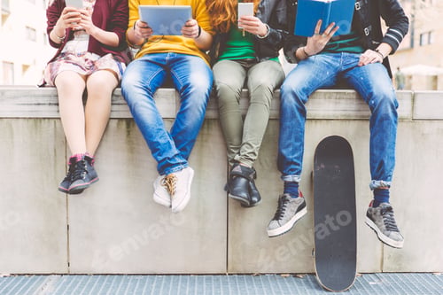 Preview: Group of teenagers making different activities sitting in an urban area