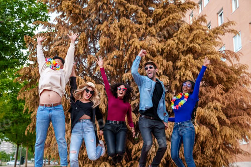 Preview: Joyful Multiethnic Group with Party Accessories Enjoying Birthday Bash under Colorful Trees.
