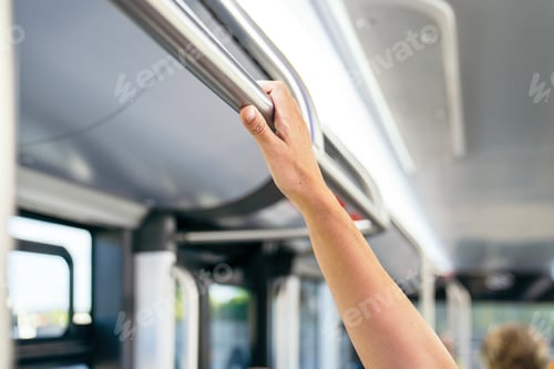 Preview: Commuter hand holding handle on public bus