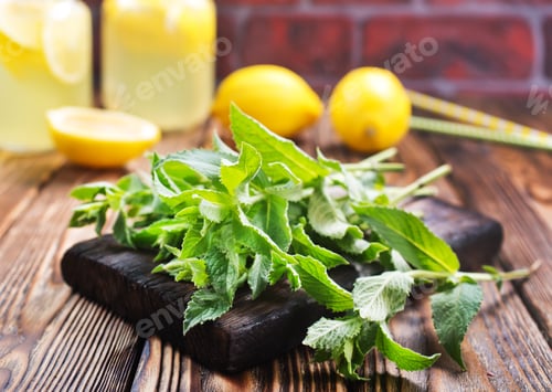 Fresh Mint and Lemons on Wooden Cutting Board