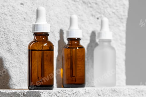 Preview: Glass jar of skincare serum on concrete block