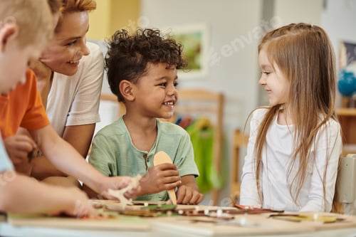Preview: cheerful multiethnic kids playing near teacher during lesson in montessori school