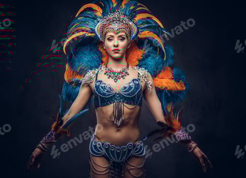 Preview: Portrait of a female in a colorful sumptuous carnival feather suit. Isolated on a dark background.