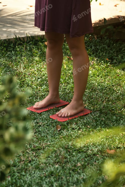 Preview: Young Woman Engaging in Challenging Yoga Practice on Sadhu Board Outdoors