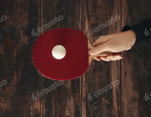 Preview: Red Ping Pong Paddle with Ball on Wood