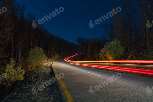 Preview: Car headlamp light in night mountain road