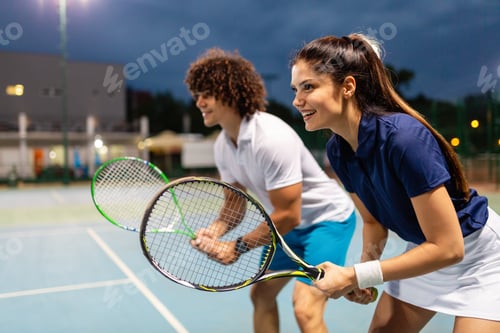 Preview: Tennis sport people concept. Mixed doubles player hitting tennis ball with partner standing near net