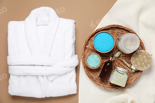 Preview: Flat lay composition with bathrobe and spa essentials on brown background
