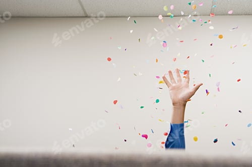Preview: Businessman throwing confetti in the air