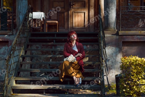 Preview: Girl sitting on old house stairs