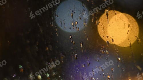Preview: Raindrops on dirty window surface with bokeh lights background