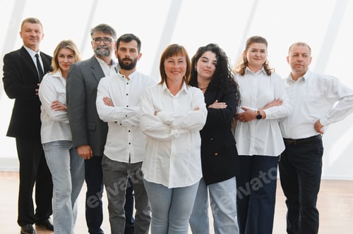 Preview: Business team standing together in unity and confidence