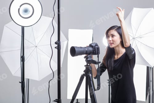 Preview: Photographer taking picture in studio