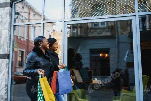 Preview: two happy African American girl friends going shopping