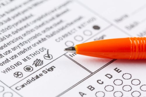 Preview: Filling out a form with a pen in a clear space on a desk