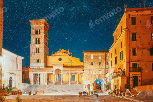 Preview: Terracina, Italy. Bold Bright Blue Night Starry Sky With Glowing Stars Above Tower Of Cathedral Of