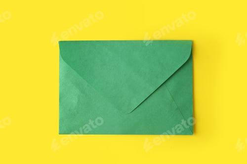 Preview: Green paper envelope on yellow background, top view