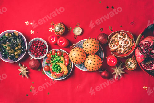 Preview: Vegan Christmas appetizers, olive, orange, fruits, vegetable salads, candles, tangerine, pomegranate
