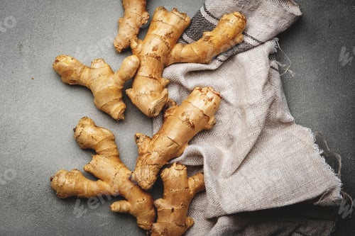 Preview: Fresh ginger root. Gray kitchen table background, top view