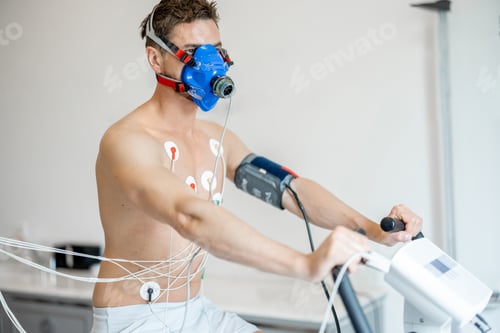 Preview: Man examining his cardiovascular system on bike simulator