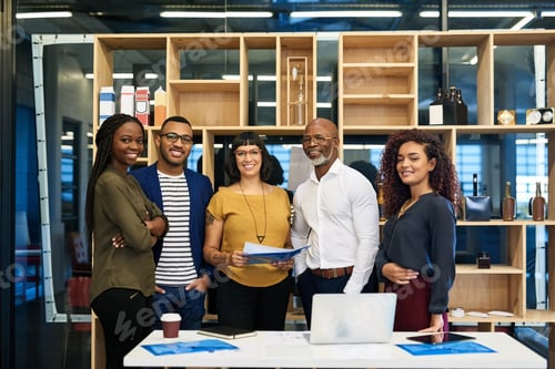Preview: Portrait of a group of designers posing together in their office