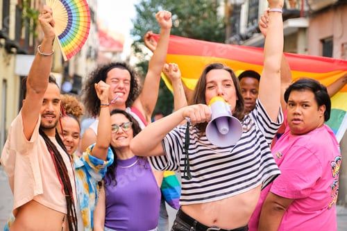 Preview: LGBTQ people with rainbow flags and a megaphone fighting for their rights.