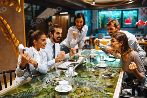 Preview: Young business people meeting at a cafe success concept
