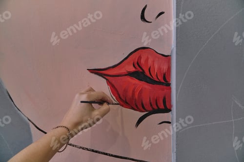 Preview: Girl artist paints a picture of pop art on the wall