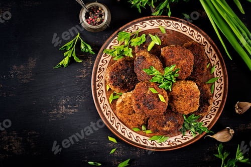 Preview: Juicy delicious meat cutlets on a dark table. Russian cuisine. Top view
