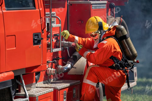 Preview: Firefighter wearing fire protection suite and oxygen tank exercise roll hose connect with fire truck
