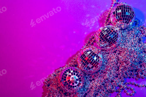 Preview: Shiny small disco balls sparkling in a beautiful purple light. Disco party concept