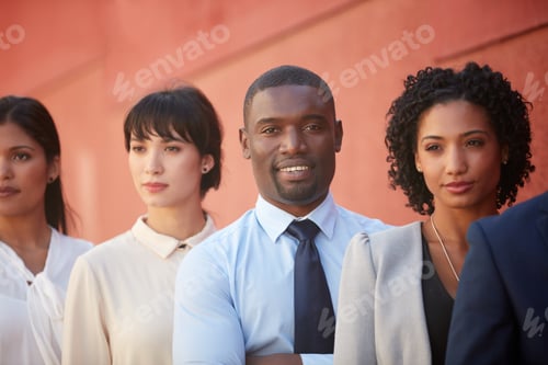Preview: Portrait of a young businessman standing amongst his colleagues outdoors