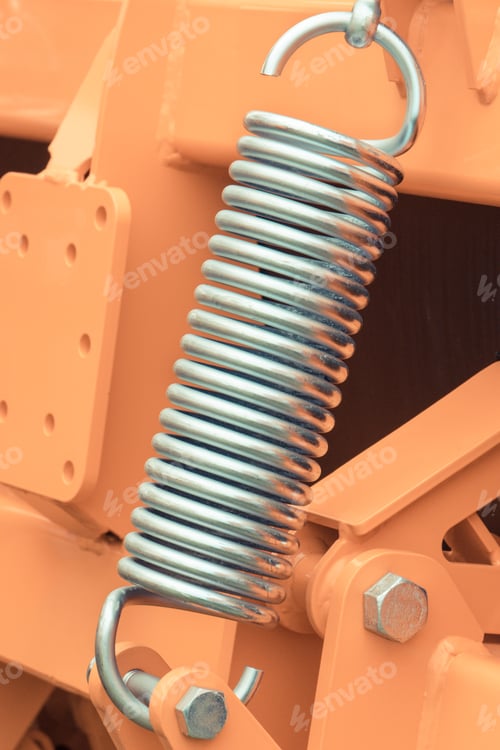 Preview: Silver hard spring made of steel. Part of big industrial or agricultural machine