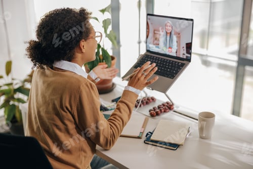 Preview: Smiling business woman have video conference with client while sitting in office