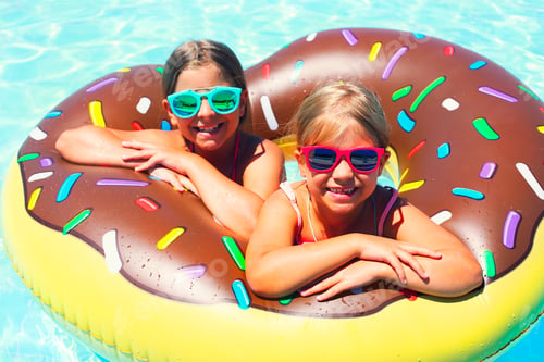 Preview: Two small girls having fun in pool