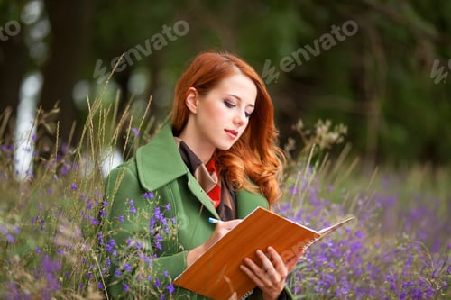 Preview: Redhead girl with note at outdoor