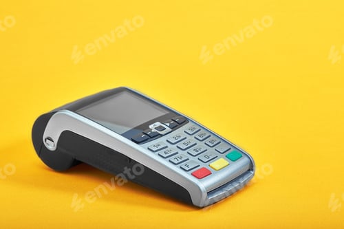 Preview: Payment terminal, compact POS terminal on yellow background top view copy space.