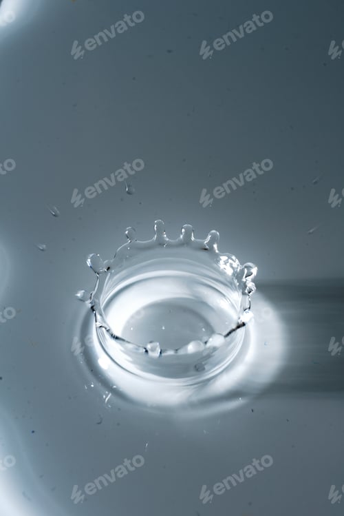 Preview: Vertical top view shot of water splash isolated on gray background