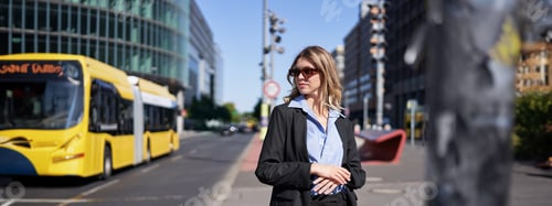 Preview: Portrait of confident corporate woman, young saleswoman in suit and sunglasses, looking self