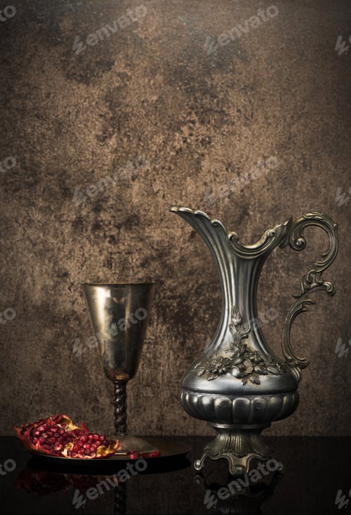 Preview: Retro still life with jug wine, metal goblet and a pomegranate