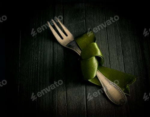 Vintage Fork with Green Ribbon on Dark Wood