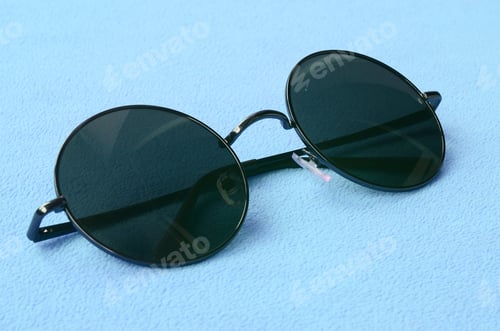 Preview: Stylish black sunglasses with round glasses lies on a blanket
