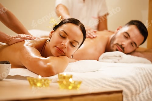 Preview: Young coupe enjoying in back massage at the spa.