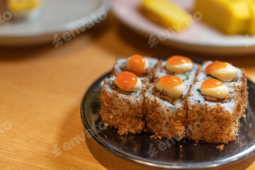 Preview: close up of sushi with chopsticks and soy