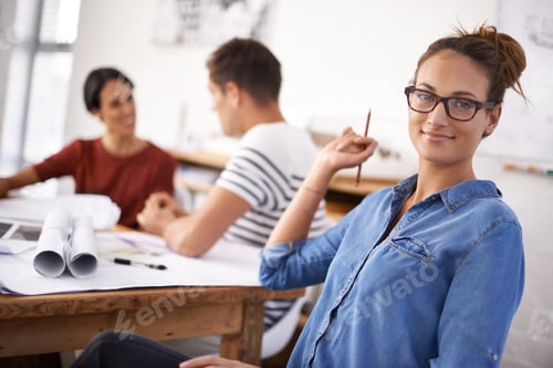 Preview: Shot of a group of young designers working together in an office
